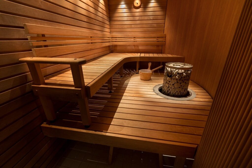 A wood-lined sauna interior with bench seating