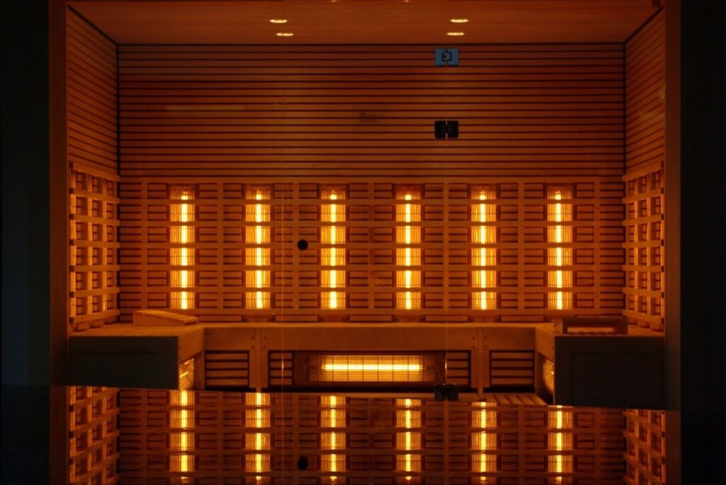 Interior of a home infrared sauna with glowing carbon heater panels